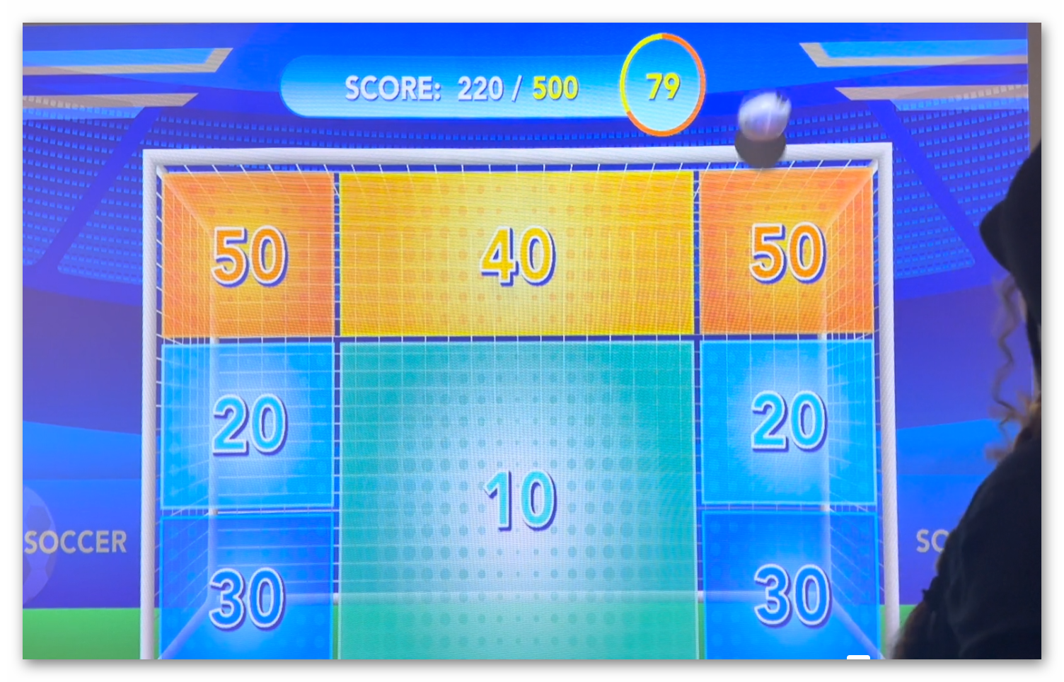 Multiple players engaging with soccer mode Ball Wall Arena interactive sports experience