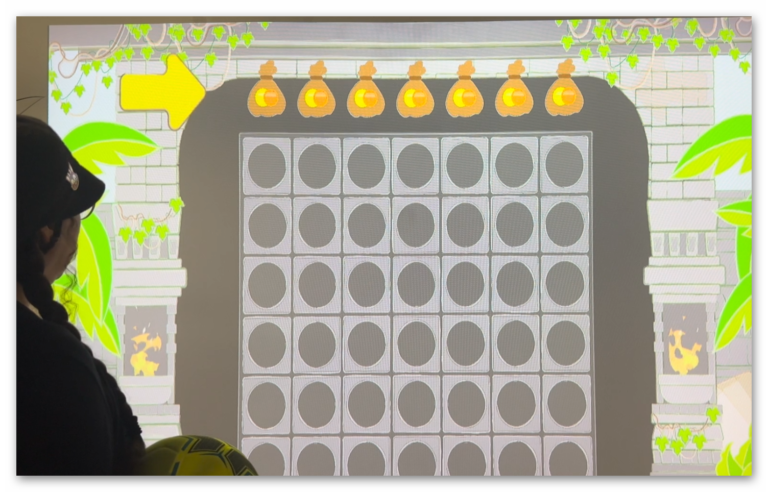 Live gameplay photo 2 showing players throwing balls at Coin Temple Connect 4 interactive wall projection