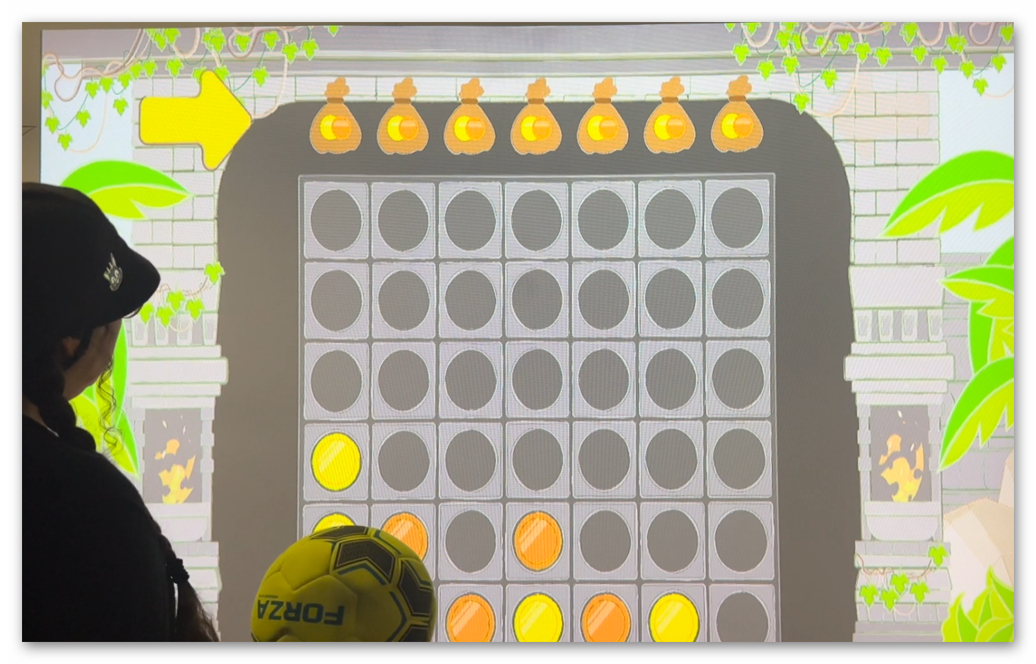 Live gameplay photo 3 showing players throwing balls at Coin Temple Connect 4 interactive wall projection