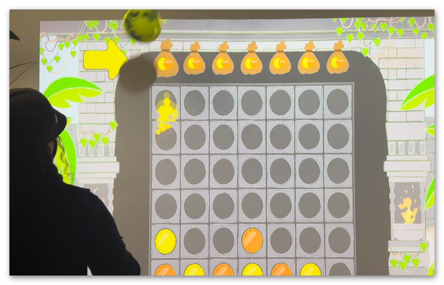 Live gameplay photo 4 showing players throwing balls at Coin Temple Connect 4 interactive wall projection