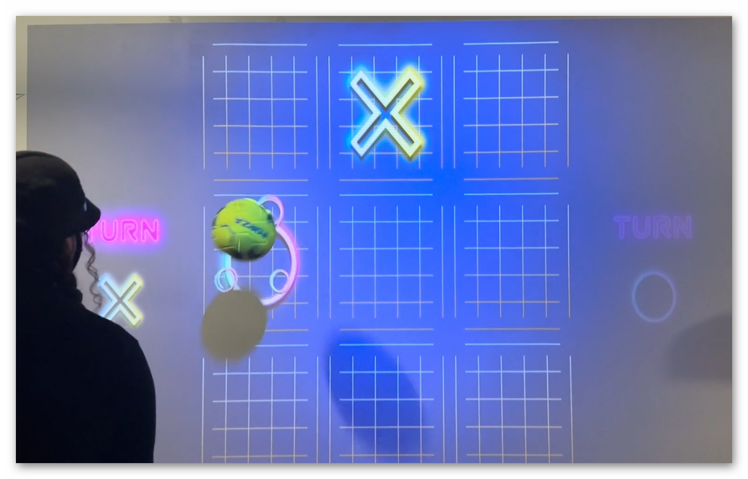 Family entertainment center featuring interactive wall game with multiple players